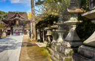 Stone lanterns at the entrance to the Kitano Tenmangu Shrine in Kyoto.