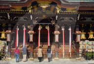 People praying at Kitano Tenmangu Shrine in Kyoto.