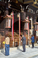 People praying at Kitano Tenmangu Shrine in Kyoto.