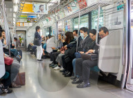 Passengers on a Tokyo subway train.