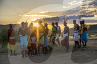 Portrait Samburu tribe members dancing the traditional wedding dance at dusk, Kenya.