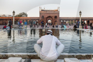 Muslim man washing hands and feet before prayer time, Jama Masjid, one of the largest mosques in India.