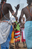 Portrait Samburu tribe members dancing the traditional wedding dance at dusk, Kenya.