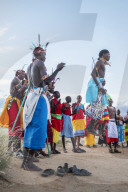 Portrait Samburu tribe members jumping at traditional wedding dance at dusk, Kenya.