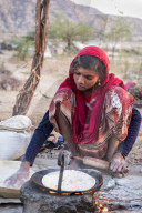 Portrait of young Hindu girl cooking bread, Pushkar.