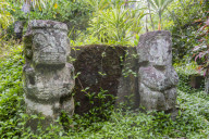 Twin tikis marking the Christian gravesite of Te hau moe in Puama'u, Hiva Oa, Marquesas, French Polynesia.