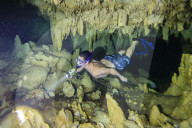 A snorkeler explores the fresh water grotto formations at Makatea, Tuamotus, French Polynesia.