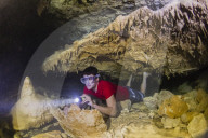 A snorkeler explores the fresh water grotto formations at Makatea, Tuamotus, French Polynesia.
