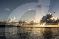 Snorkelers at sunset at Niau Atoll, Tuamotus, French Polynesia.