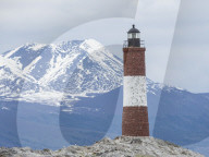 Lighthouse with Andes Mountains in the background on a small islet in the Beagle Channel, Ushuaia, Argentina.