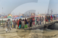 Pilgrims crossing the Ganges river on a temporary pontoon bridge, Allahabad Kumbh Mela, Uttar Pradesh, India