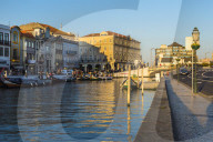 Moliceiros moored along the main canal at sunset. Aveiro, Venice of Portugal, Beira Littoral, Portugal