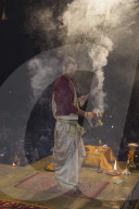 Priest celebrating the river Ganges Aarti by offering incense, Dashashwamedh Ghat, Varanasi, Uttar Pradesh, India