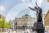 A statue and the Polish Academy of Sciences in the background in the Old Town, a UNESCO World site in Warsaw, Poland, Europe.