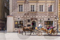 A horse drawn carriage passing beautiful architecture in the old town, a UNESCO World Heritage site in Warsaw, Poland, Europe.