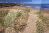 The remote sandy beach at Red Point with the Isle of Skye on the horizon, Wester Ross, Scotland, United Kingdom, Europe.