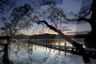 Sunset at Rigg Wood jetty on Coniston Water, Lake District National Park, Cumbria, England, United Kingdom, Europe.
