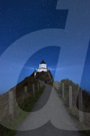 8205 Nugget Point lighthouse under star filled sky, Kaka Point, New Zealand