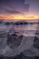 Epic sunrise at Moeraki Beach with the Moeraki Boulders, Moeraki Beach, Otago, New Zealand.