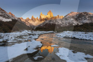 Mountain range with Cerro Fitz Roy at sunrise reflected in river, Los Glaciares National Park, El ChaltÃ©n, Patagonia, Argentina,