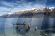 Decayed jetty, old wooden posts in Lake Wakatipu at Glenorchy, Otago Region, Southland, New Zealand