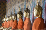 Seated Buddha statues in a row at Wat Pho (Temple of the Reclining Buddha), Bangkok, Thailand
