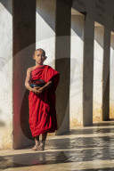 Novice Buddhist monk holding a bowl in Shwezigon Pagoda in Nyaung U., Bagan (Pagan), Myanmar (Burma), Asia