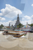 Wat Arun, Temple of Dawn, Ruea Hang Yao or long tail boat on the Chao Phraya River, at sunset, Bangkok, Thailand,