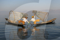 Two Intha leg rowing fisherman holding up fishing nets, Inle Lake., Shan State, Myanmar