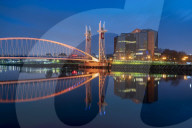 The Footbridge reflected in the River Irwell at night, Salford Quays, Manchester UK
