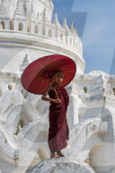 Young novice monk standing on temple walls, Mingun, Saigang, Myanmar