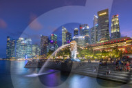 The Merlion at Marina Bay with The Fullerton Hotel set against The Financial District at night, Singapore