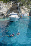 Tourists snorkelling at the Blue Caves, Paxos, Ionian Islands, Greece