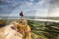 A rambler looking across The Cheshire Plains from Cloudside near Congleton, Cheshire.