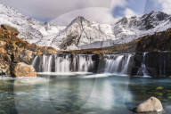 Cascades beneath the snow-covered Black Cuillin, Fairy Pools, Glen Brittle, Isle of Skye, Inner Hebrides, Highland, Scotland.