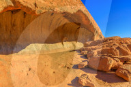 Wave shaped rock formation along Mala Walk at base of Ayers Rock in Uluru-Kata Tjuta National Park in Northern Territory, Australia. This popular walk goes from Mala carpark to Kantju Gorge. Blue sky.