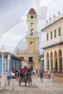 Street scene at Plaza Mayor, a UNESCO World Heritage Site in Trinidad, Cuba. St. Francis Church in the background.