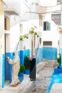Two woman in local dress at neighbouring front door, Kasbah des Oudaias, UNESCO World Heritage Site, Rabat, Morocco