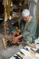 Man saws horn to make combs in an alleyway in the Old City (Medina) of Fez, UNESCO World Heritage Site, Morocco