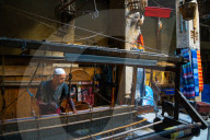 Weaver at work at loom in shop in the Old City (Medina) of Fez, UNESCO World Heritage Site, Morocco (Model Release)