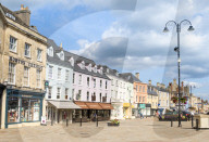 Shops and businesses on the Market place Cirencester town centre Cirencester Wiltshire england UK GB Europe