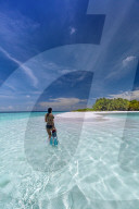 women with snorkelling gear in tropical beach, maldives