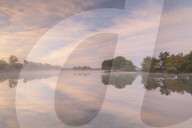 Hatchet Pond reflecting a beautiful pink misty sunrise, Beaulieu, New Forest, England. Autumn (November) 2018.