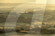 Rolling countryside near Moretonhampstead at dawn, Dartmoor National Park, Devon, England. Winter (January) 2019.