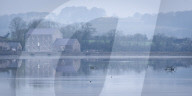 Carew Tidal Mill, on a misty Spring morning, Pembrokeshire, Wales, UK. Spring (March) 2019.