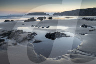 Tidal pools on Marloes Sands beach at twilight, Pembrokeshire Coast National Park, Wales, UK. Spring (March) 2019.