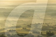 Mist covered rolling countryside at dawn, Abergavenny, Wales, UK. Spring (May) 2019.