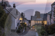 Pink dawn sky above the pretty village of Clovelly on the North Devon coast, England. Spring (April) 2019.