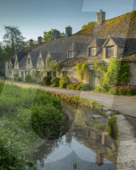 Arlington Row cottages in the pretty Cotswold village of Bibury, Gloucestershire, England. Spring (May) 2019.