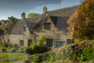 Idyllic cottages in Arlington Row in the pretty Cotswolds village of Bibury, Gloucestershire, England. Spring (May) 2019.